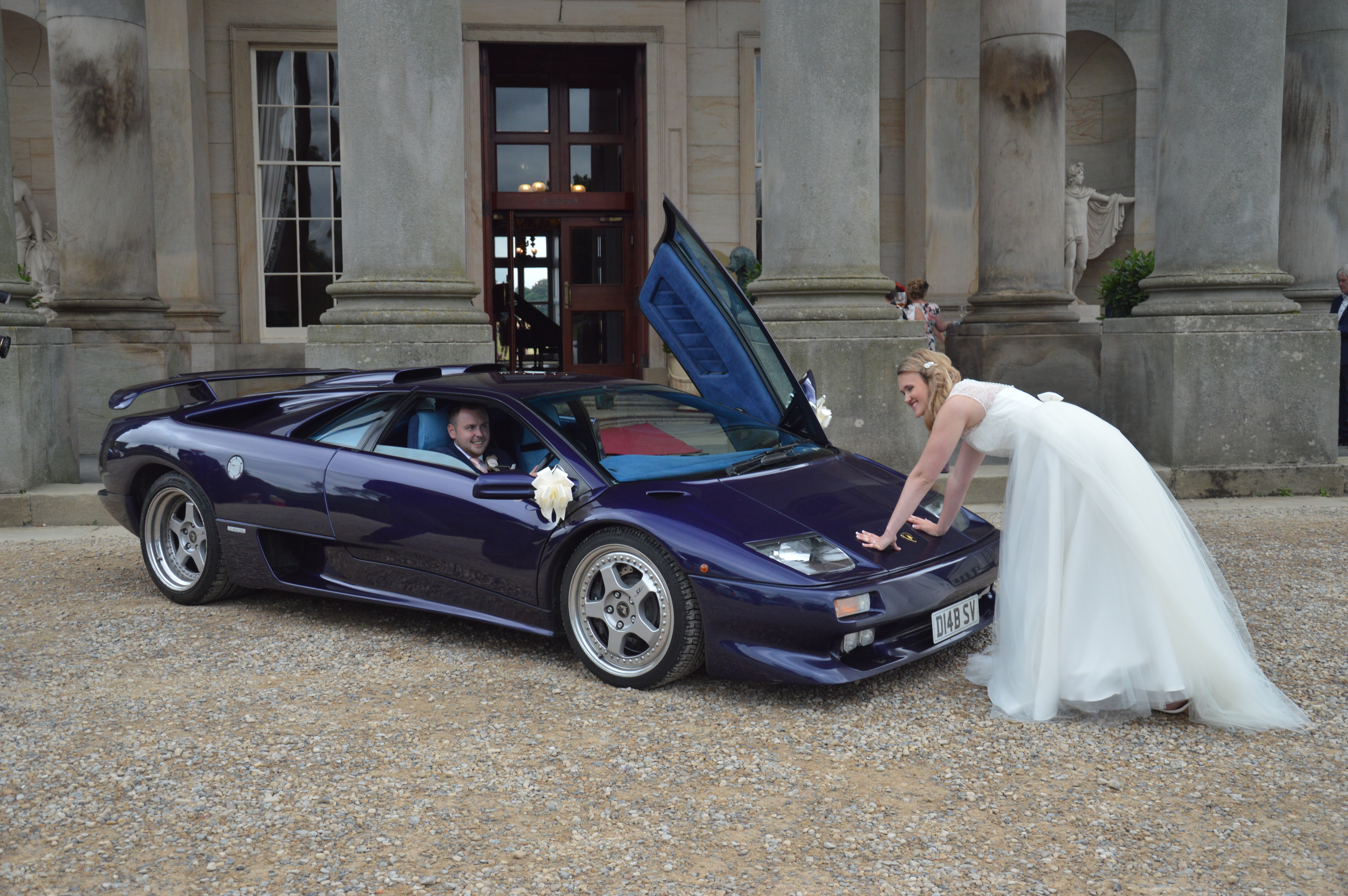 Bride pushing Wedding Lamborghini with Groom inside